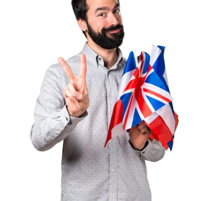 Handsome man with beard holding many flags and counting two