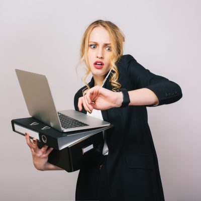 Work office busy time of blonde young woman in formal clothes with laptop, folder talking on phone on white background. Astonished, working, profession, secretary, office worker, manager